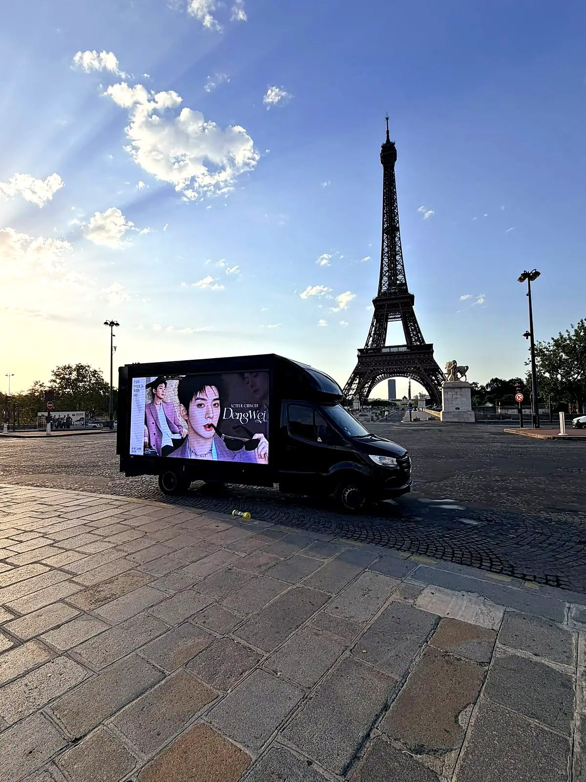 LED truck at the Pont d'Iéna facing the Eiffel Tower at dawn
